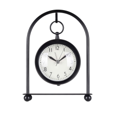 Metal globe alarm clock hanging on a arched wrought iron stand